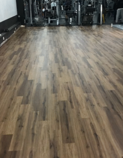 Durable Luxury Vinyl Tile flooring in a fitness facility, showcasing seamless transitions for high-traffic areas and aesthetic appeal.