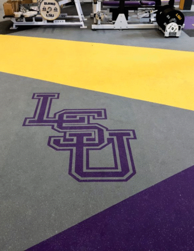 LSU logo applied on sports flooring with vibrant purple and yellow colors, showcasing custom branding for athletic facilities.