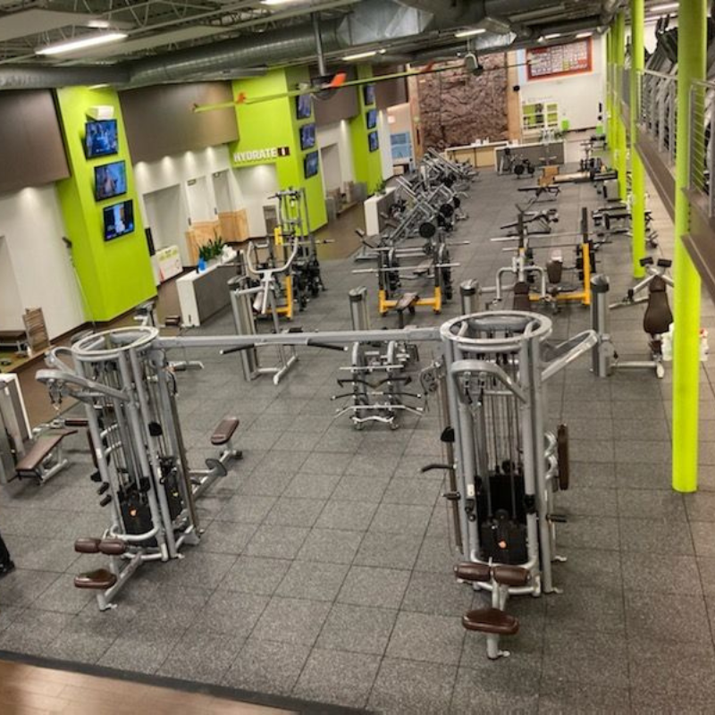 Gym interior featuring modern fitness equipment and rubber flooring, designed for athletic training and performance, aligned with Sport Pro Surfacing's custom flooring solutions.