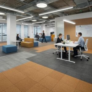 Modern commercial office space featuring various noise-reducing flooring solutions, including orange and gray tiles, with people working and collaborating at desks.